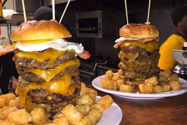 The John Henry Challenge at Local 7 in Tucker includes seven burger patties with a fried egg and cheese, along with tater tots or fries. / Courtesy of Local 7