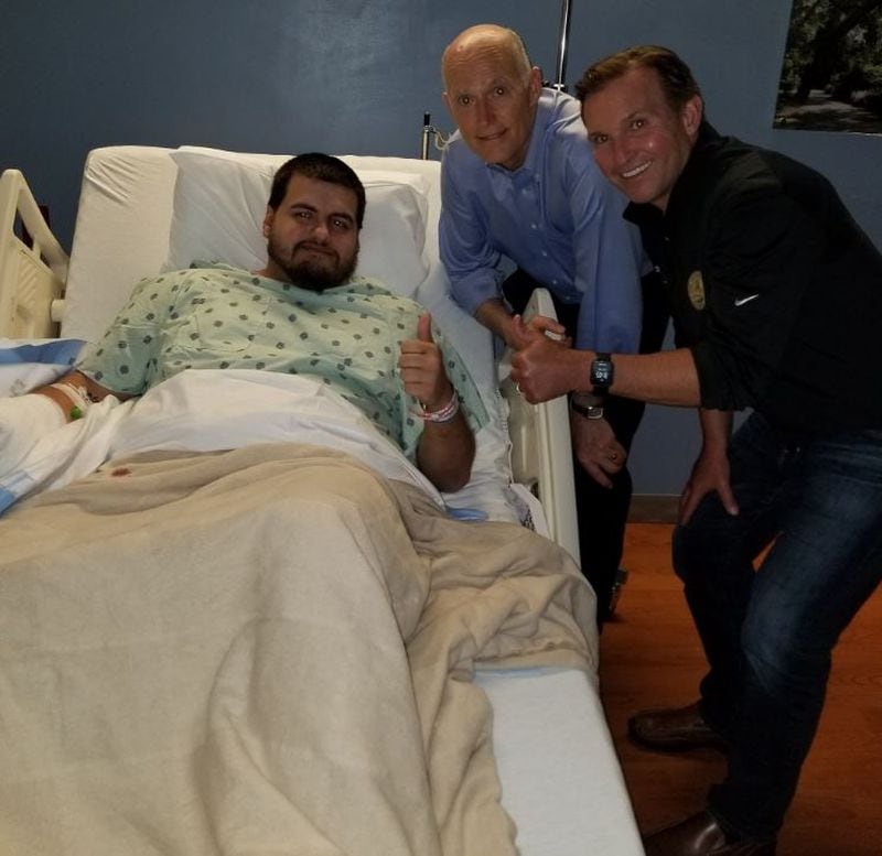 Jacksonville "Madden" mass shooting victim Timothy Anselmo in UF Health Jacksonville with Gov. Rick Scott of Florida and Jacksonville Mayor Lenny Curry.