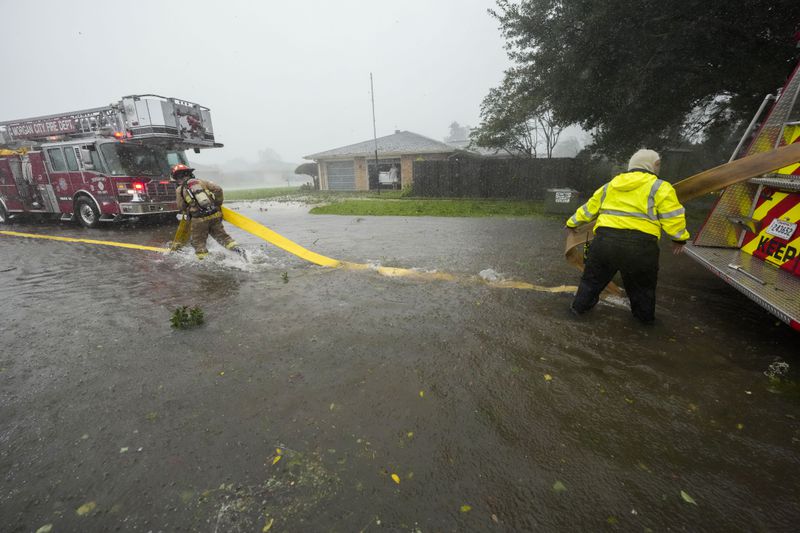 Morgan City firefighters respond to a home fire during Hurricane Francine in Morgan City, La., Wednesday, Sept. 11, 2024. (AP Photo/Gerald Herbert)