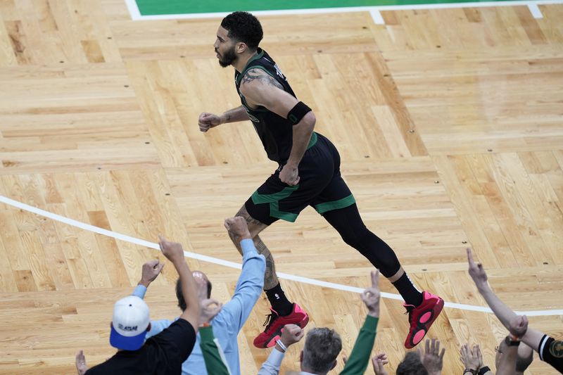 Boston Celtics forward Jayson Tatum runs back to defend after scoring during the second half of Game 2 of the NBA Eastern Conference basketball finals against the Indiana Pacers, Thursday, May 23, 2024, in Boston. (AP Photo/Michael Dwyer)