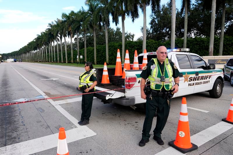 Officers with the Palm Beach County Sheriff's office work outside of Trump International Golf Club after the apparent assassination attempt of Republican presidential nominee and former President Donald Trump Monday, Sept. 16, 2024, in West Palm Beach, Fla. (AP Photo/Lynne Sladky)