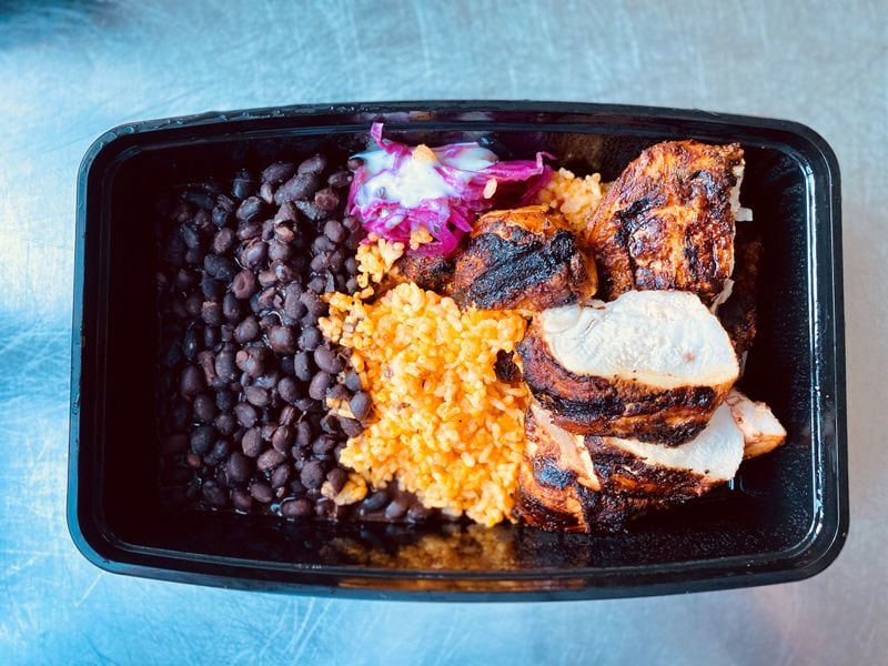 Bar Mercado’s grilled chicken is served with beans, rice and Salvadoran slaw. Wendell Brock for The Atlanta Journal-Constitution