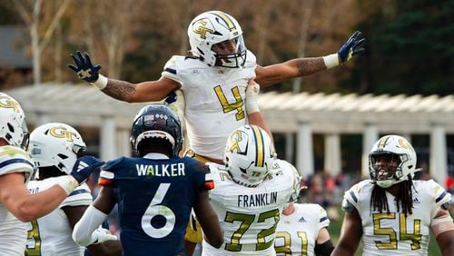 Georgia Tech running back Dontae Smith (4) is lifted in the air by offensive lineman Weston Franklin (72) after scoring a touchdown against Virginia during the second half of an NCAA college football game Saturday, Nov. 4, 2023, in Charlottesville, Va. (AP Photo/Mike Caudill)