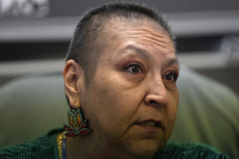 Julie Manning, who is currently battling cancer, speaks at the tribal health clinic where she works as an accounting specialist on March 15, 2024, in Owyhee, Nev., on the Duck Valley Indian Reservation that straddles the Nevada-Idaho border. (AP Photo/Rick Bowmer)