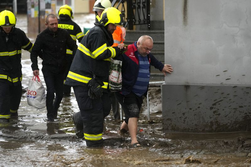 Firemen help residents during floods in Jesenik, Czech Republic, Sunday, Sept. 15, 2024. (AP Photo/Petr David Josek)