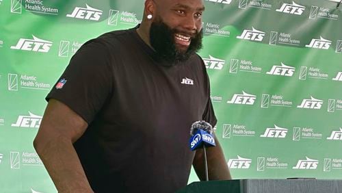New York Jets offensive tackle Morgan Moses speaks to reporters after his first training camp practice in Florham Park, N.J., Friday, Aug. 2, 2024. (AP Photo/Dennis Waszak Jr.)