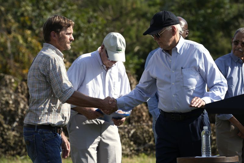 President Joe Biden shakes hands with Buck Paulk, property manager of Shiloh Pecan Farm, during Thursday's visit to Ray City.