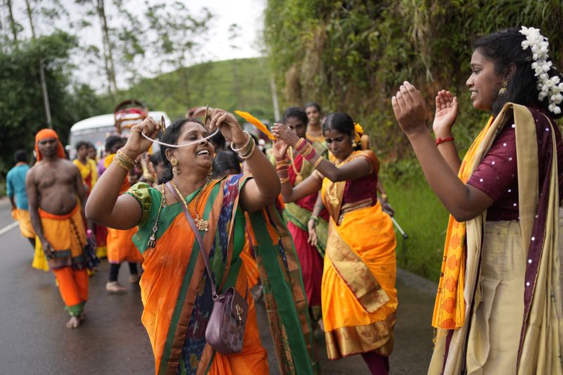 Tea plantation workers dance during a Hindu religious procession in Hatton, Sri Lanka, Sunday, Sept. 8, 2024. (AP Photo/Eranga Jayawardena)