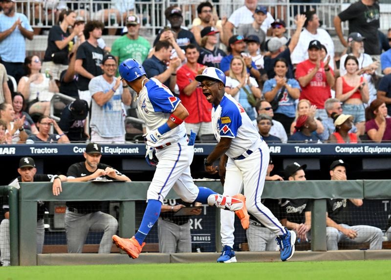 Braves third-base coach Ron Washington (right) reacts as Eddie Rosario circles the bases on a solo home run against the Chicago White Sox during the third inning. (Hyosub Shin / Hyosub.Shin@ajc.com)