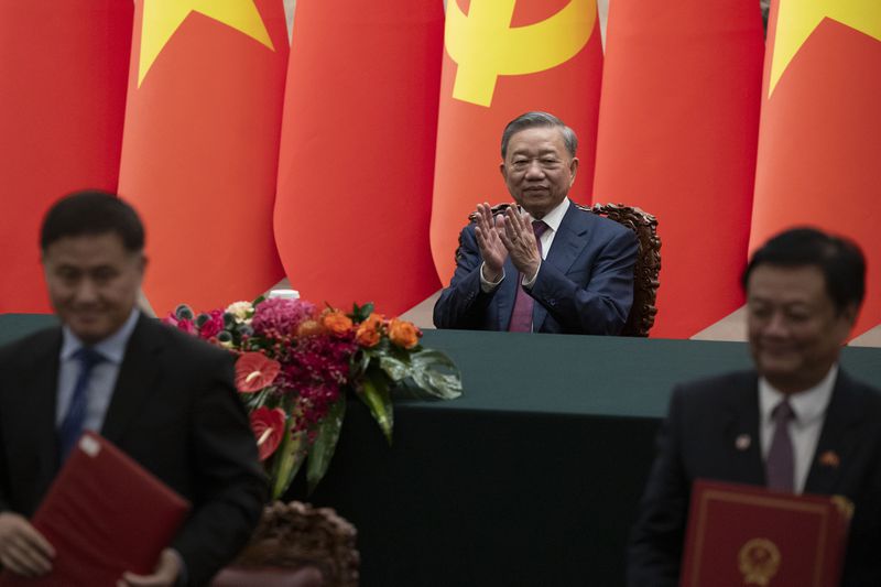 Vietnam's President To Lam, center, applauds during a signing ceremony at the Great Hall of the People in Beijing Monday, Aug. 19, 2024. (Andres Martinez Casares/Pool Photo via AP)