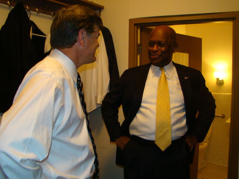 Sean Hannity with Herman Cain backstage at the Fox Theatre in 2012 during a retirement party for Neal Boortz. Hannity said Cain, who died July 30, 2020, "lit up a room" whenever he entered it. Photo: Rodney Ho/AJC