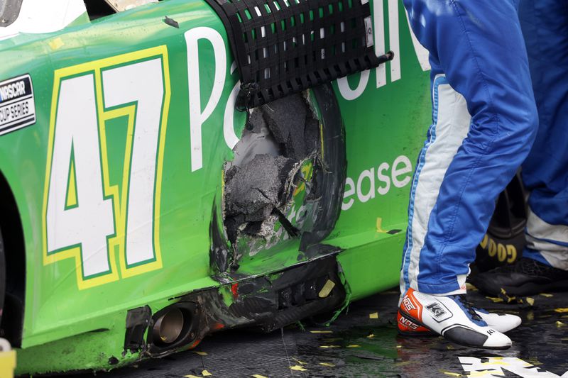 Driver Ricky Stenhouse Jr.'s car shows damage from a wreck in the last few laps of a NASCAR Cup Series auto race at Talladega Superspeedway, Sunday, Oct. 6, 2024, in Talladega, Ala. (AP Photo/ Butch Dill)