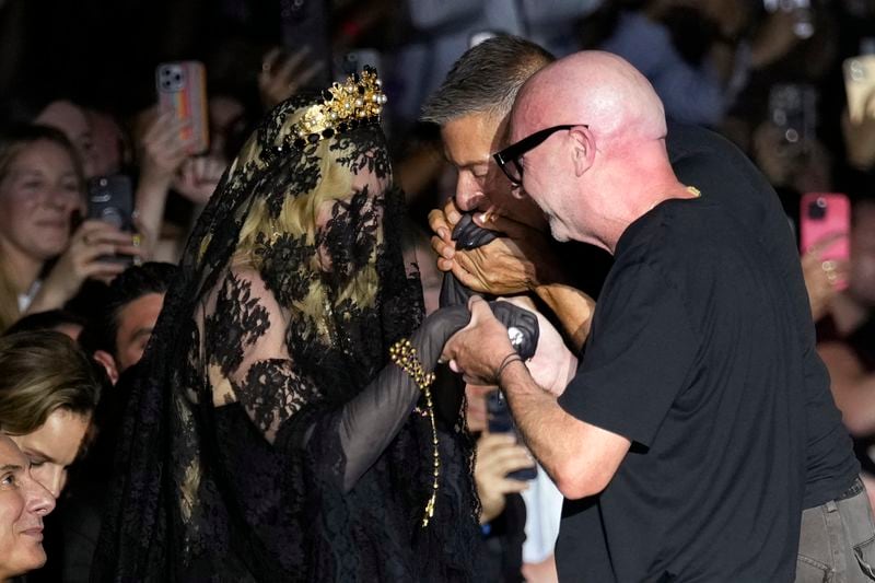 Italian designers Stefano Gabbana, centre, and Domenico Dolce, right, with Madonna at the end of the Dolce & Gabbana Spring Summer 2025 fashion show, that was presented in Milan, Italy, Saturday, Sept. 21, 2024. (AP Photo/Antonio Calanni)