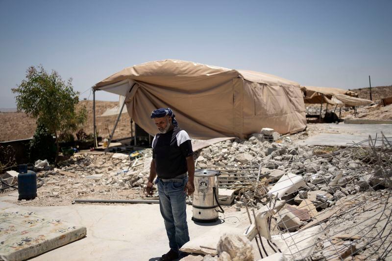 FILE - Yasser Hathaleen stands in the ruins of his family home in the West Bank village of Umm al-Khair, on July 10, 2024. (AP Photo/Maya Alleruzzo, File)