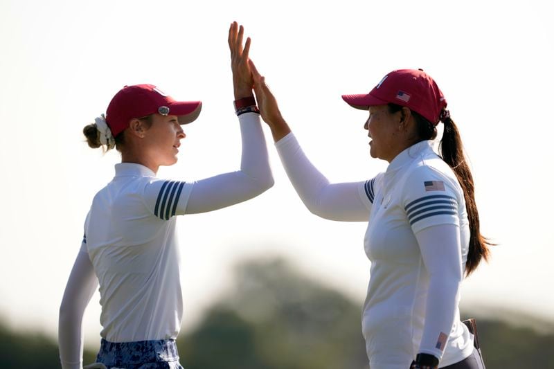 United States' Nelly Korda, left, is celebrates with teammate Allisen Corpuz after sinking a putt on the 10th hole during a Solheim Cup golf tournament foursome match at Robert Trent Jones Golf Club, Saturday, Sept. 14, 2024, in Gainesville, Va. (AP Photo/Matt York)