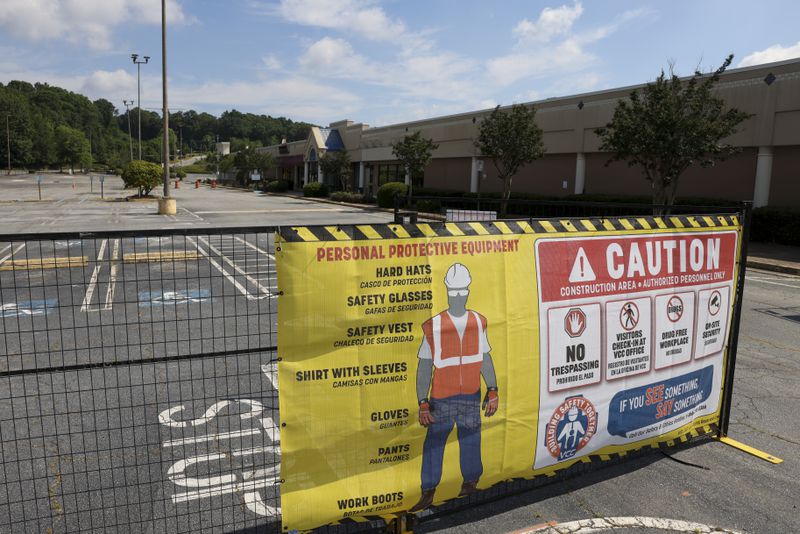 A sign for personal protection equipment is shown outside of gates to the North DeKalb Mall, Monday, June 24, 2024, in Decatur, Ga. The North DeKalb mall is scheduled to be demolished starting Wednesday morning, June 26th. (Jason Getz / AJC)
