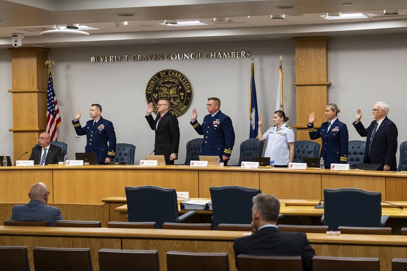 Coast Guard members of the investigative board for the Titan marine board formal hearing take an oath inside the Charleston County Council Chambers Monday, Sept. 16, 2024, in North Charleston, S.C. (AP Photo/Mic Smith)