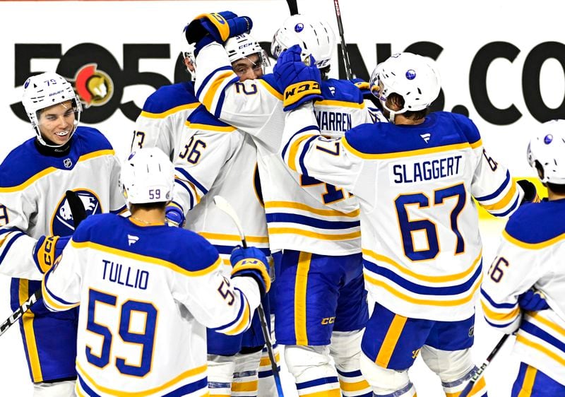 Buffalo Sabres' Noah Ostlund (36) is surrounded by teammates after his goal to defeat the Ottawa Senators in preseason NHL hockey game action in Ottawa, Ontario, Thursday, Sept. 26, 2024. (Justin Tang/The Canadian Press via AP)