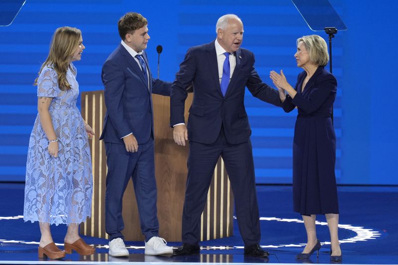 Democratic vice presidential nominee Minnesota Gov. Tim Walz, second from right, appears on stage with his wife Gwen Walz, from right, son Gus Walz and daughter Hope Walz after speaking during the Democratic National Convention Wednesday, Aug. 21, 2024, in Chicago. (AP Photo/J. Scott Applewhite)