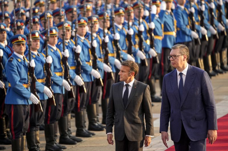 French President Emmanuel Macron, left, reviews the honor guard along with Serbian President Aleksandar Vucic during a welcoming ceremony in Belgrade, Serbia, Thursday, Aug. 29, 2024. French President Emmanuel Macron starts a two-day state visit to Serbia with the focus on a possible sale of 12 Rafale multi-purpose fighter jets to a country that has maintained close ties to Russia despite its aggression on Ukraine. (AP Photo/Darko Vojinovic)