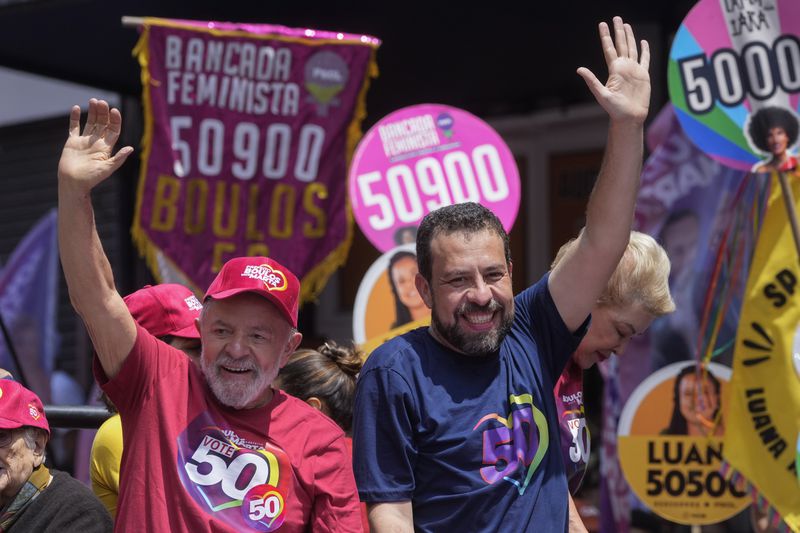 Brazilian President Luiz Inacio Lula da Silva, left, campaigns with mayoral candidate Guilherme Boulos of the Socialism and Liberty Party the day before elections in Sao Paulo, Saturday, Oct. 5, 2024. (AP Photo/Andre Penner)