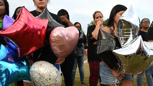 Community members gathered at Jug Tavern Park on Wednesday, September 4, 2024, to mourn victims of a mass shooting at Apalachee High School. (Hyosub Shin / AJC)