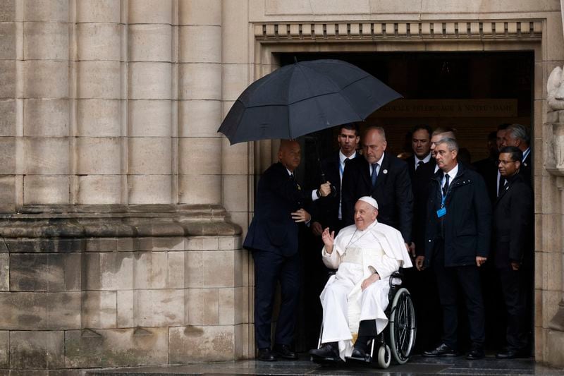 Pope Francis greets children after meeting with the Catholic Community in the Luxembourg's Cathedral of Notre-Dame on the first day of his four-day visit to Luxembourg and Belgium, Thursday, Sept. 26, 2024. (AP Photo/Omar Havana)