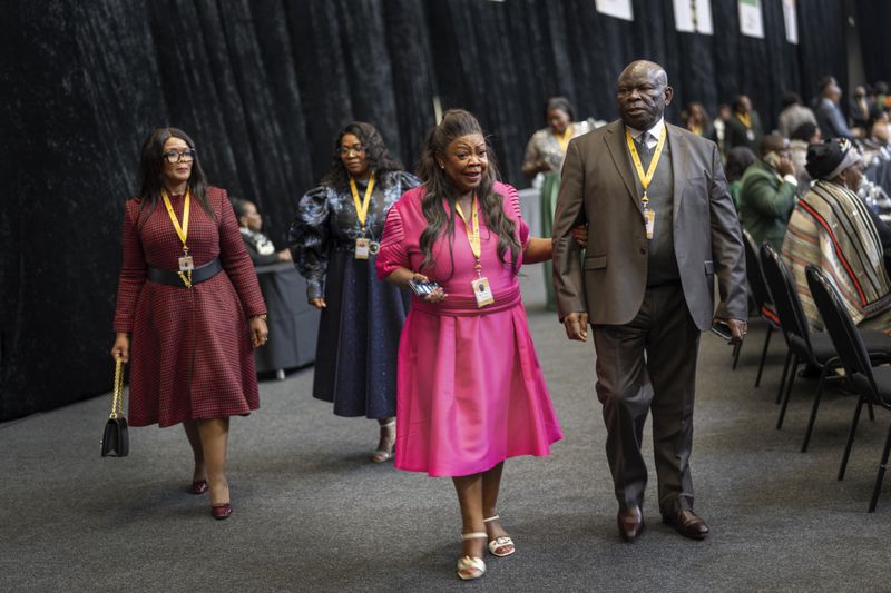 Lawmakers and guests break during the first sitting of the National Assembly following the swearing in of lawmakers as members of parliament in Cape Town, South Africa, Friday, June 14, 2024, ahead of a vote to decide if South African President Cyril Ramaphosa is reelected as leader of the country. (AP Photo/Jerome Delay)
