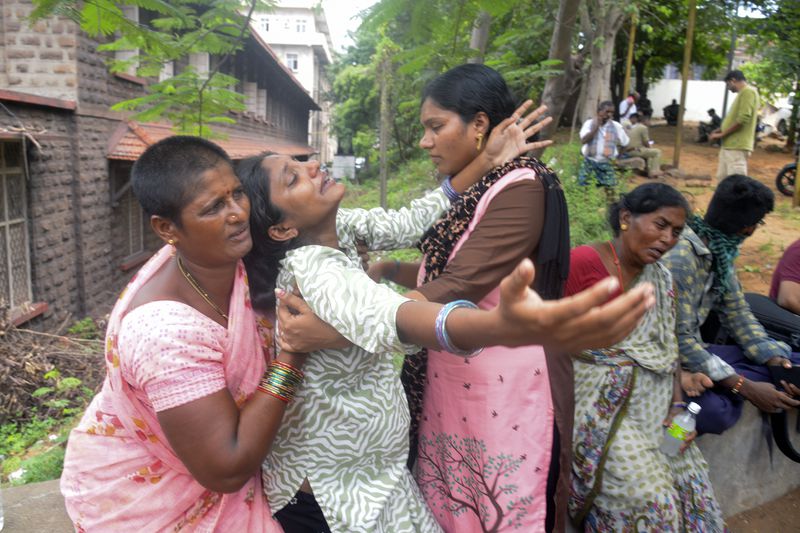 Leela Devi, center, with her arms outstretched, wails after hearing of her husband Chiranjeevi's death in an explosion at the Escientia Advanced Sciences Private Ltd., a pharmaceutical company, outside the mortuary of King George Hospital in Visakhapatnam, Andhra Pradesh state, India, Thursday, Aug. 22, 2024. (AP Photo)