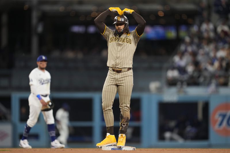 San Diego Padres' Fernando Tatis Jr. celebrates after a ground-rule double during the third inning of a baseball game against the Los Angeles Dodgers in Los Angeles, Wednesday, Sept. 25, 2024. (AP Photo/Ashley Landis)