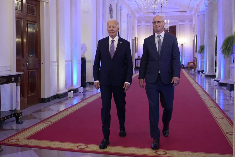 President Joe Biden walks with University of Connecticut Huskies Men's basketball team head coach Dan Hurley during and event in the East Room of the White House in Washington, Tuesday, Sept. 10, 2024, to welcome the Huskies and celebrate their 2023-2024 NCAA championship season. (AP Photo/Susan Walsh)