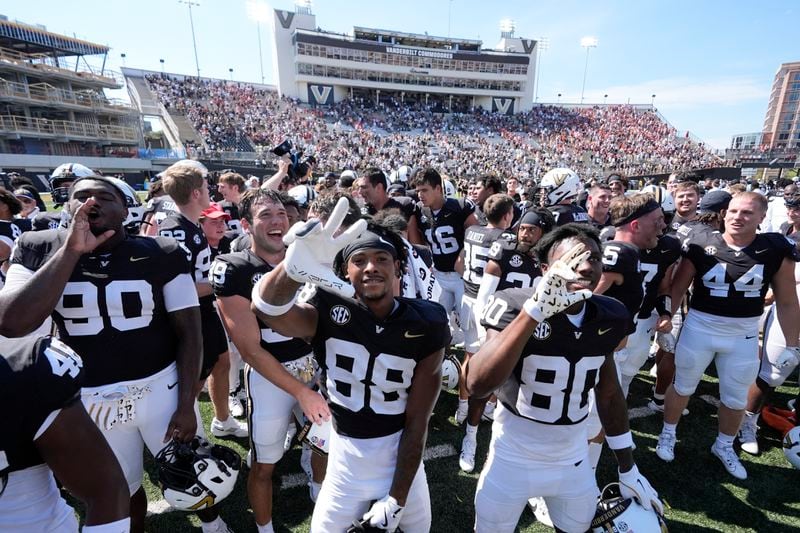 Vanderbilt players celebrate the team's 34-27 overtime win after an NCAA college football game against Virginia Tech, Saturday, Aug. 31, 2024, in Nashville, Tenn. (AP Photo/George Walker IV)