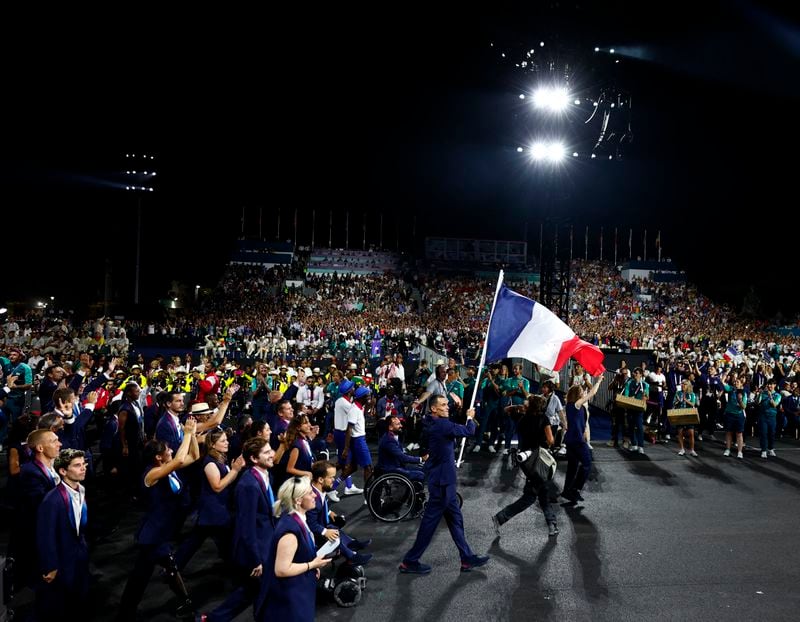 Flagbearers Alexis Hanquinquant of France and Nantenin Keita of France lead their delegation during the Opening Ceremony for the 2024 Paralympics, Wednesday, Aug. 28, 2024, in Paris, France. (Gonzalo Fuentes/Pool Photo via AP)