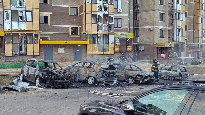 This photo released by Belgorod regional governor Vyacheslav Gladkov's Telegram channel on Monday, Sept. 2, 2024, Firefighters extinguish burning cars in the courtyard of an apartment building after a missile attack by the Armed Forces of Ukraine on the city of Belgorod, Russia. (Belgorod Region Governor Vyacheslav Gladkov Telegram channel via AP)