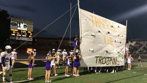 Hiram cheerleaders prepare the run-through sign. (Photo courtesy of Hiram Facebook page)