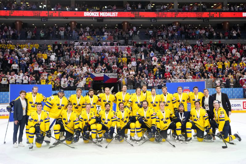 Players of Sweden celebrate after the bronze medal match between Sweden and Canada at the Ice Hockey World Championships in Prague, Czech Republic, Sunday, May 26, 2024. (AP Photo/Petr David Josek)