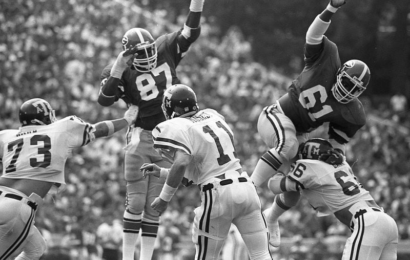 Georgia Bulldogs defensive linemen Jimmy Payne (87) and Eddie Weaver (61) in action against Texas A&M at Sanford Stadium on Sept. 13, 1980. (AJC file photo)