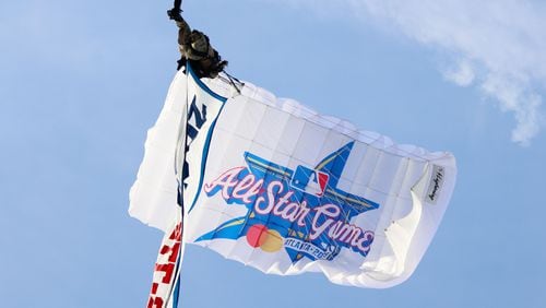 A parachute flies approaching Truist Park during the unveiling celebrations of the 2025 All-Star Game logo on Monday, July 22, 2024, in Atlanta.

(Miguel Martinez/ AJC)