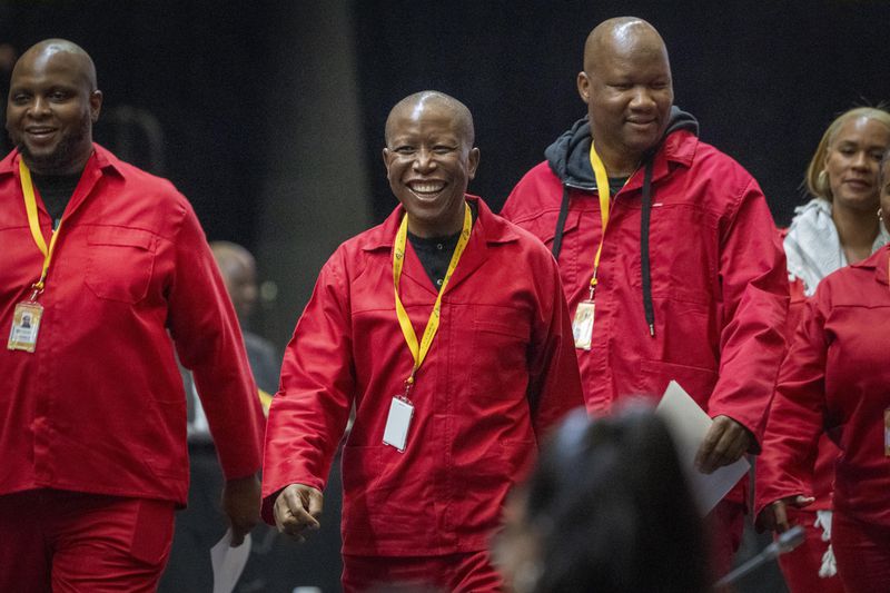 Opposition Economic Freedom Fighters President Julius Malema smiles after being sworn is as a member of Parliament ahead of an expected vote by lawmakers to decide if South African président Cyril Ramaphosa is re-elected as leader of the country in Cape Town, South Africa, Friday, June 14, 2024. (AP Photo/Jerome Delay)
