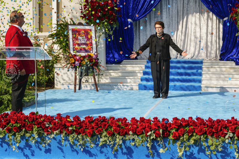 Tennis great Billie Jean King gestures as she is introduced by Roses President Ed Morales, left, as grand marshal of the 136th Rose Parade next year on the front steps of the Tournament House in Pasadena, Calif., Monday, Oct. 7, 2024. (AP Photo/Damian Dovarganes)