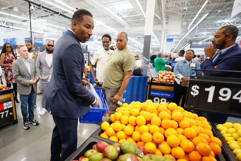 Atlanta Mayor Andre Dickens is seen getting some fruits during the reopening a former Walmart Superstore location as a Neighborhood Market in Vine City on Wednesday, May 22, 2024
(Miguel Martinez / AJC)