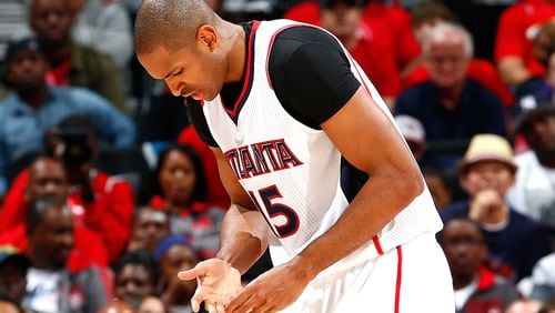 Hawks forward Al Horford holds his hand after he dislocated his right pinky finger against the Nets in Game 1 of their playoff series Sunday in Atlanta.