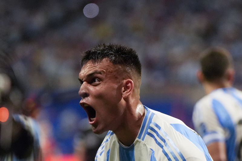 Argentina's Lautaro Martinez celebrates scoring his side's second goal against Canada during a Copa America Group A soccer match in Atlanta, Thursday, June 20, 2024. (AP Photo/Mike Stewart)