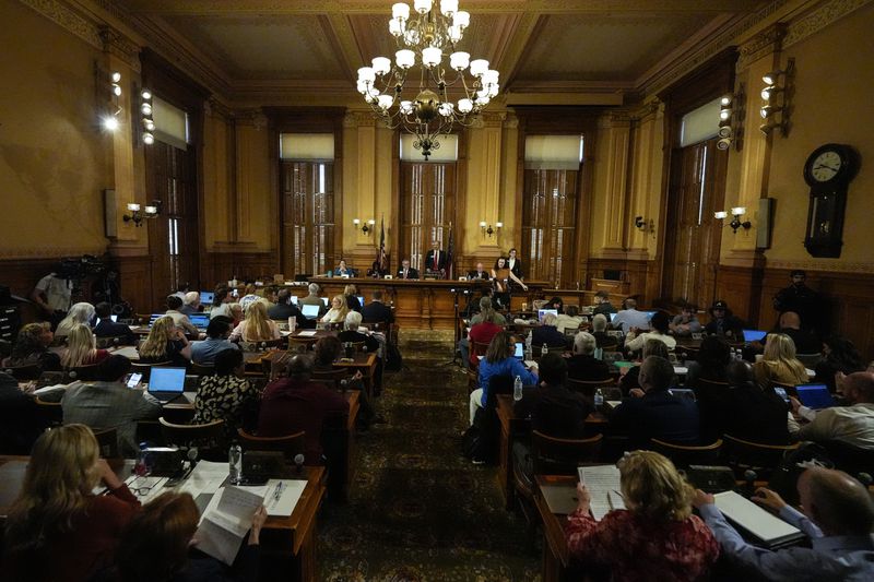 Georgia's State Election Board members discuss proposals to a full room for election rule changes at the state capitol, Friday, Sept. 20, 2024, in Atlanta. (AP Photo/Mike Stewart)