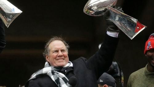In this Feb. 7, 2017, file photo, New England Patriots coach Bill Belichick holds up a Super Bowl trophy as he addresses the crowd during a rally in Boston, to celebrate the team's 34-28 win over the Atlanta Falcons in the NFL Super Bowl 51 football game in Houston. Belichick's unmatched 18-year tenure in New England made him the runaway winner in voting as the NFL's top coach by an Associated Press panel released Friday, Dec. 29, 2017 Belichick received 10 of the 11 first-place votes and 105 of a possible 110 points from a panel of Hall of Fame receiver James Lofton and 10 AP football writers. (AP Photo/Elise Amendola, File)