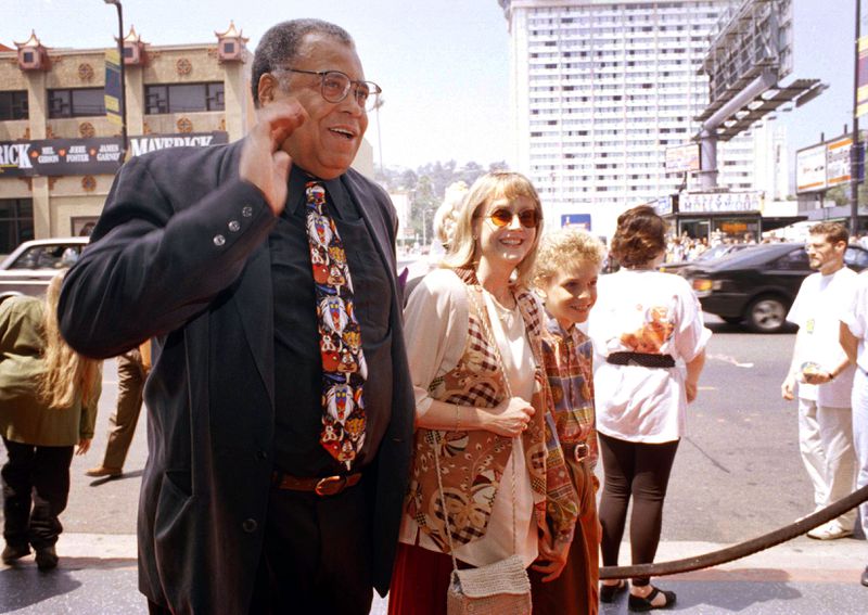 FILE - James Earl Jones, left, greets the press along with his wife Cecilia, center, and son Flynn, right, at the premiere of "The Lion King" in Los Angeles, June 12, 1994. Jones, who overcame racial prejudice and a severe stutter to become a celebrated icon of stage and screen has died at age 93, Monday, Sept. 9, 2024. (AP Photo/Tara Farrell, File)