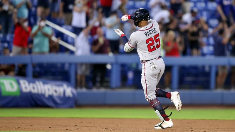 Braves center fielder Cristian Pache "stirs the drink" as he celebrates while rounding the bases after his grand slam against the Toronto Blue Jays during the second inning Saturday, May 1, 2021, in Dunedin, Fla. (Mike Carlson/AP)