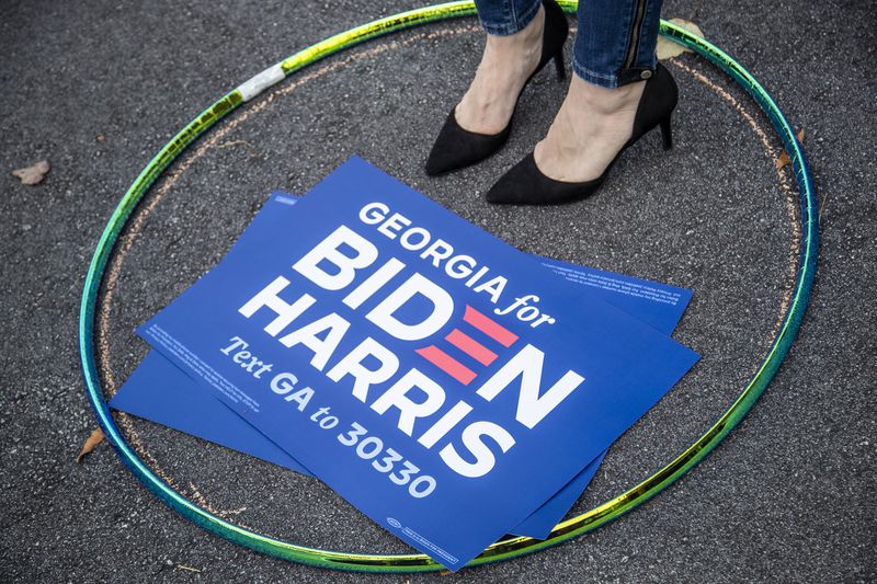 10/12/2020 - Decatur, Georgia - A Joe Biden supporter stands in a hula-hoop to ensure a social distance from other members of the audience during a rally for Presidential Democratic nominee Joe Biden and Vice President nominee Kamala Harris in downtown Decatur, Monday, October 12, 2020. The rally was hosted by Dr. Jill Biden and former Georgia gubernatorial candidate Stacey Abrams.  (Alyssa Pointer / Alyssa.Pointer@ajc.com)
