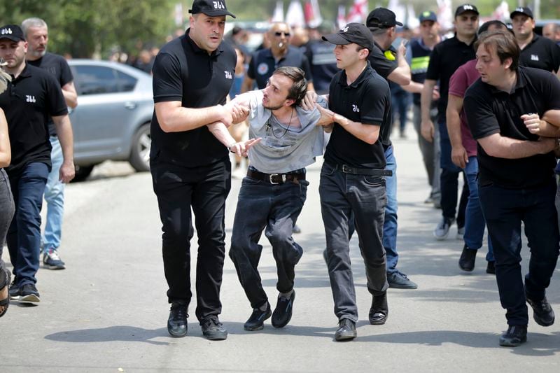 FILE - Police detain a Georgian opponent of gay rights who was shouting anti-LGBT festival slogans and tried to interfere a pride party in Tbilisi, Georgia, Saturday, July 8, 2023. (AP Photo/Zurab Tsertsvadze, File)