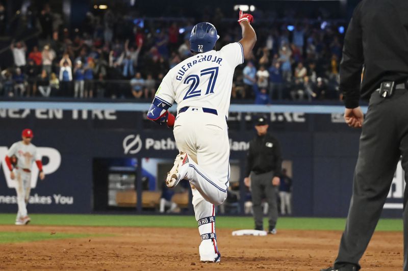 Toronto Blue Jays' Vladimir Guerrero Jr. (27) runs the bases after hitting a two-run home run against the Philadelphia Phillies in the sixth inning of a baseball game in Toronto on Tuesday Sept. 3, 2024. (Jon Blacker/The Canadian Press via AP)